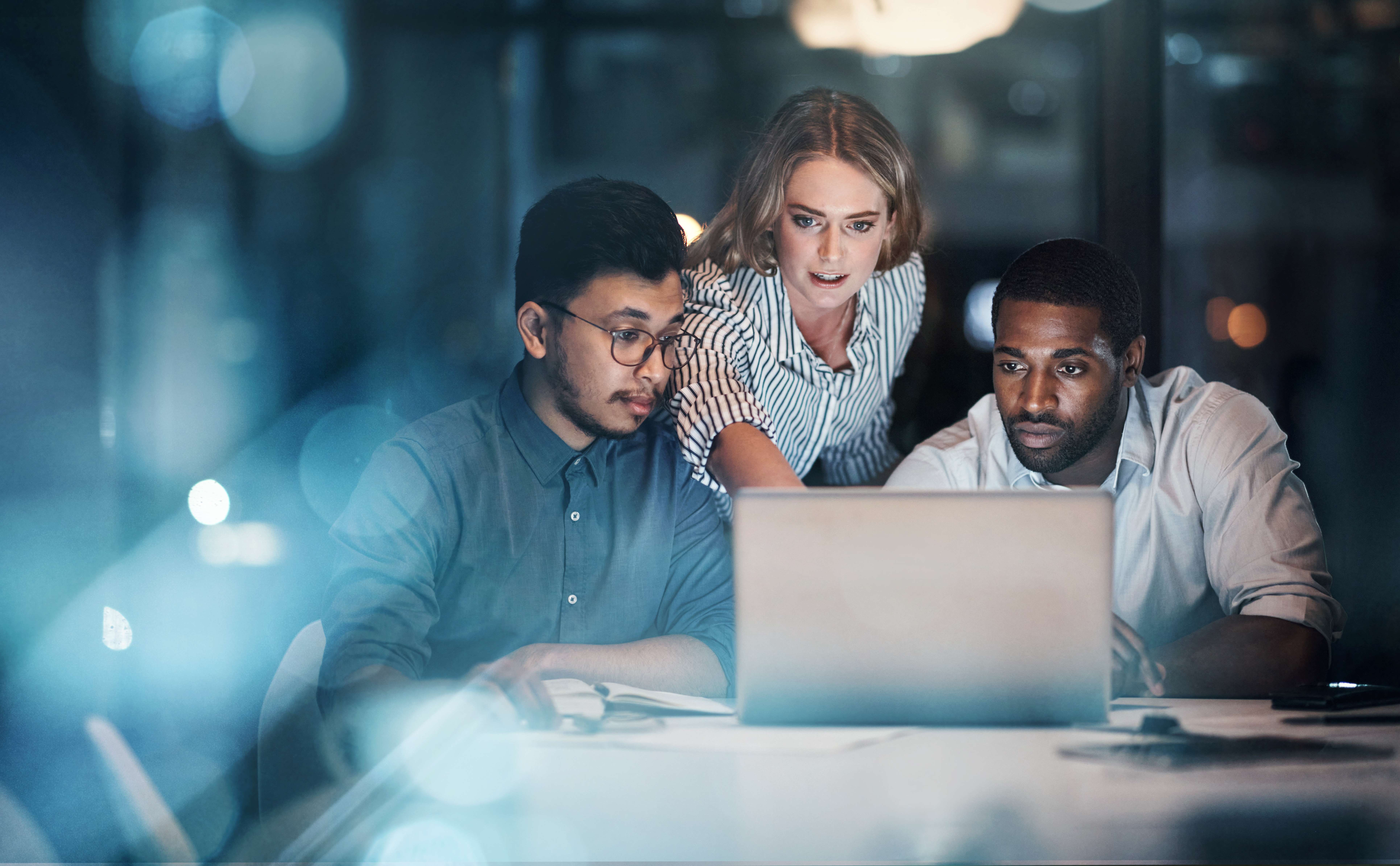 Businesspeople looking at laptop together