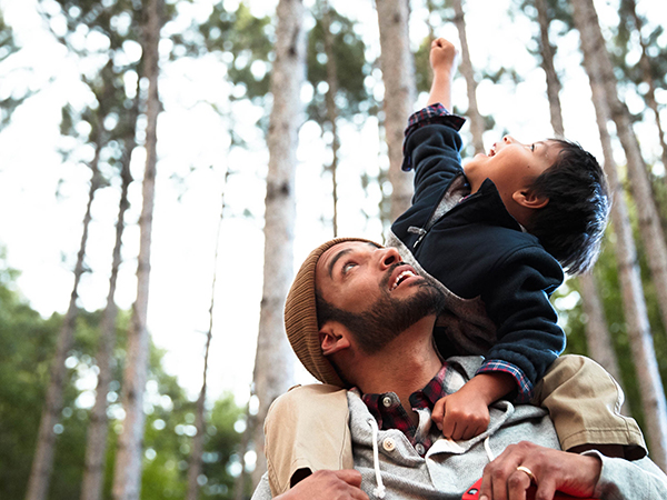 Man holding child on shoulders