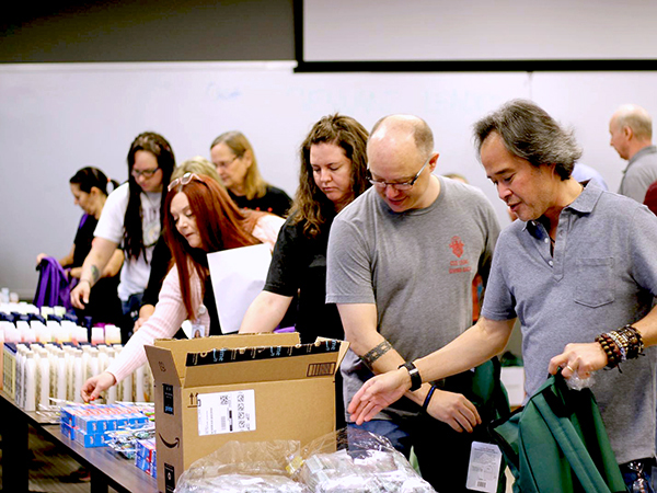 CFO Hai Tran and other CSG employees packaging supplies in a volunteer activity