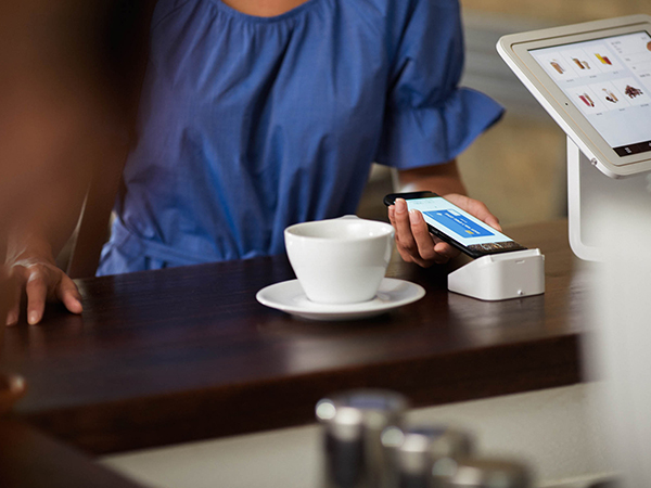 paying for coffee with mobile at coffee shop