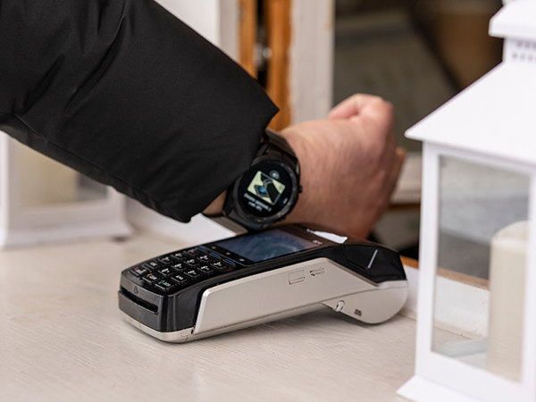 Man with smart watch paying through terminal