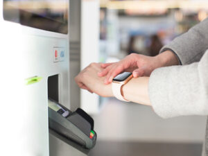 Woman paying at café with smart watch wirelessly
