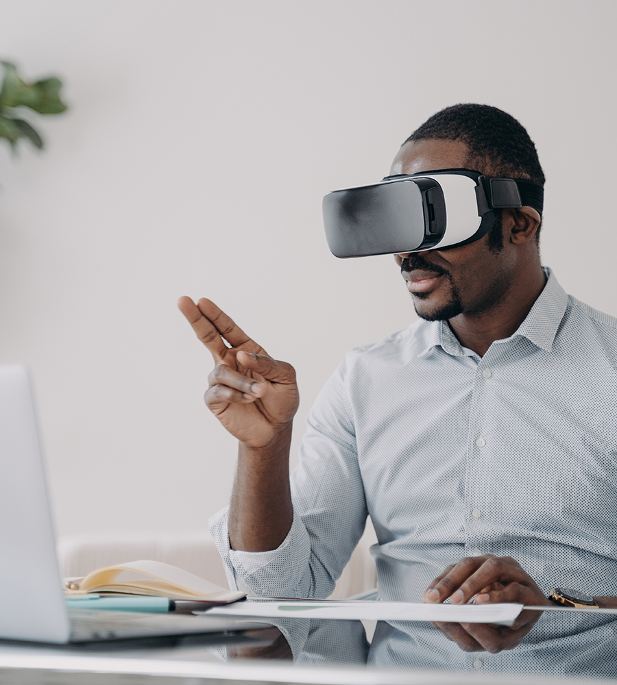 african businessman wearing vr glasses at work