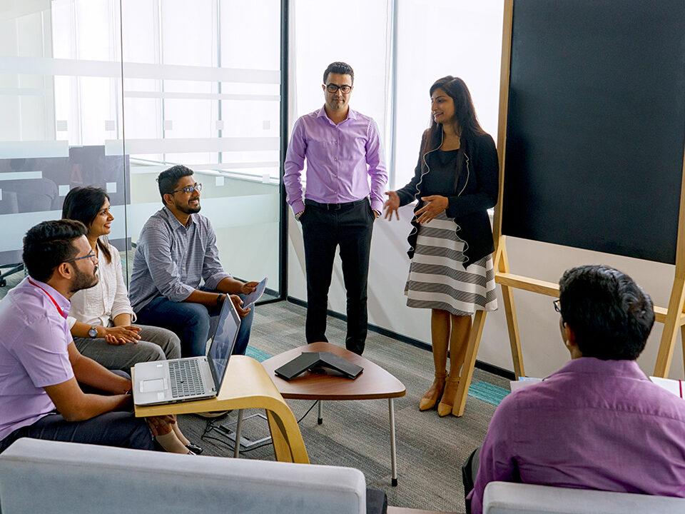 Female CSG employee giving a presentation to colleagues in the Bangalore office