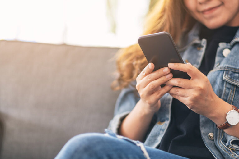 Close up of woman's hands using phone
