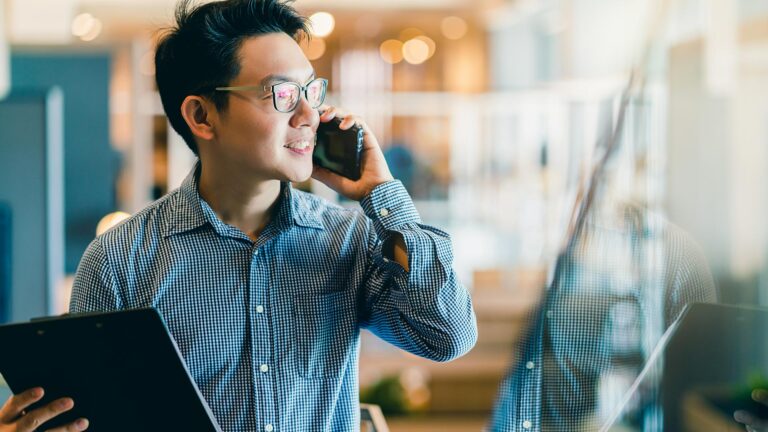 Confident, casual Asian businessman on phone