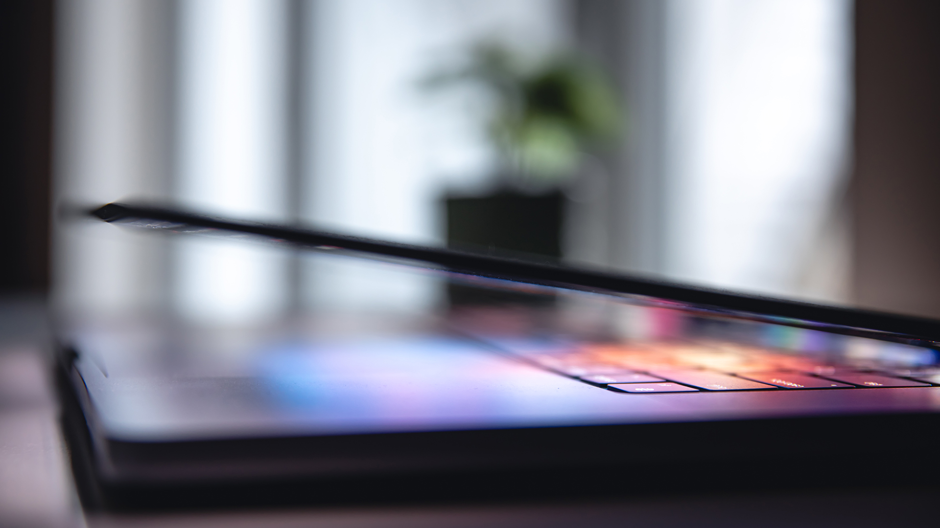close up of laptop keyboard colorful neon illumination
