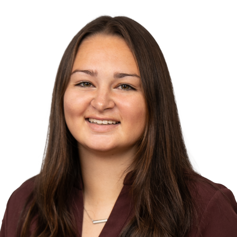 Smiling woman with long hair wearing a maroon top.