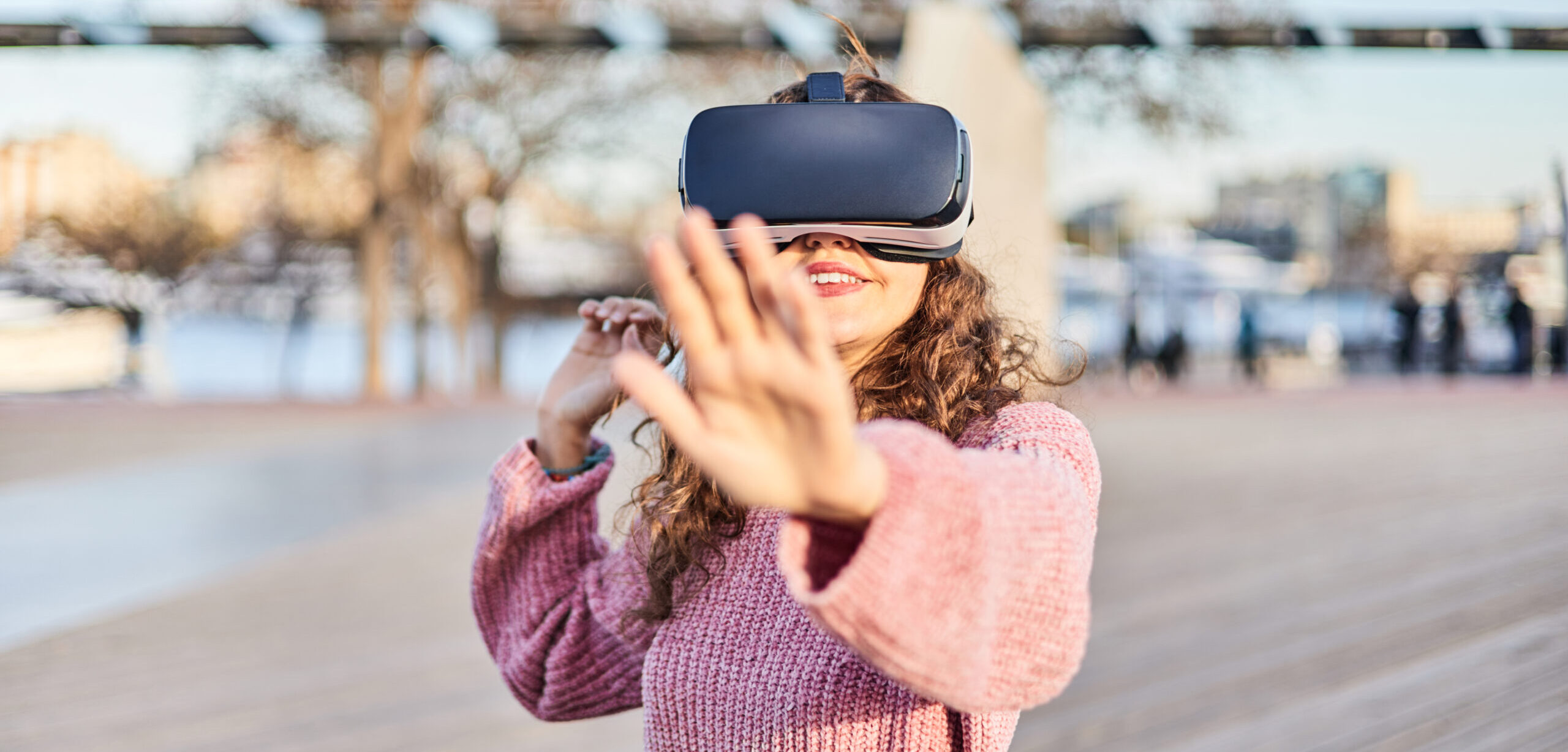 Young woman in the world of the metaverse with VR goggles