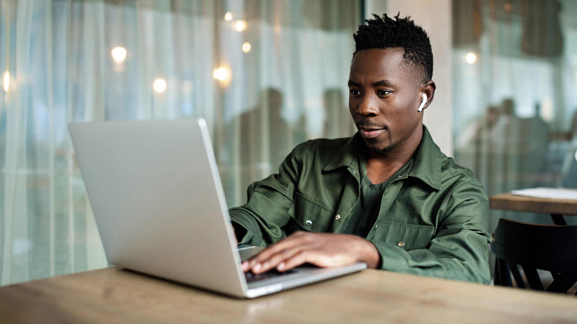 African American man using computer at a cafe