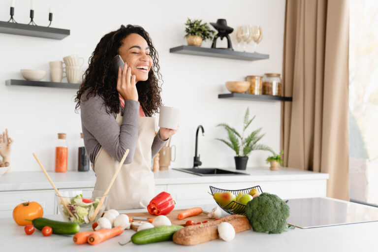 african young woman housewife chef cooking dinner making salad