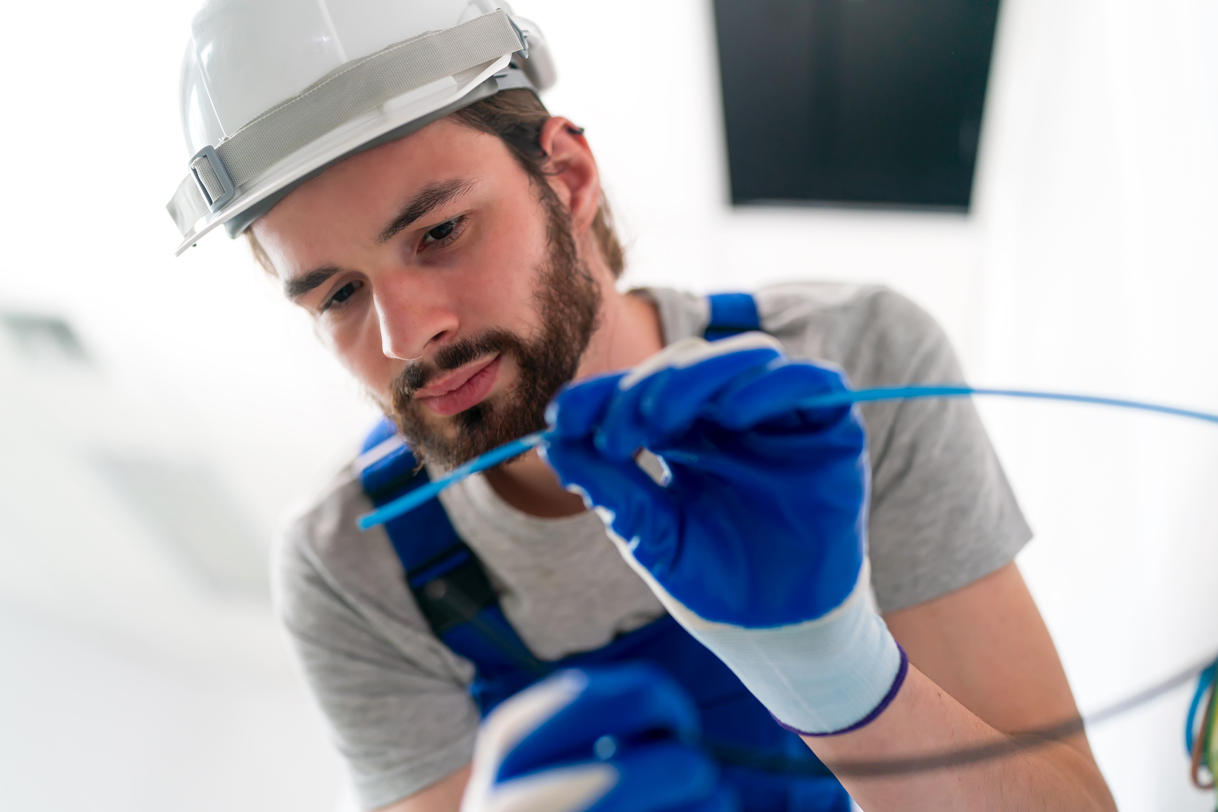 an electrician is mounting electric sockets