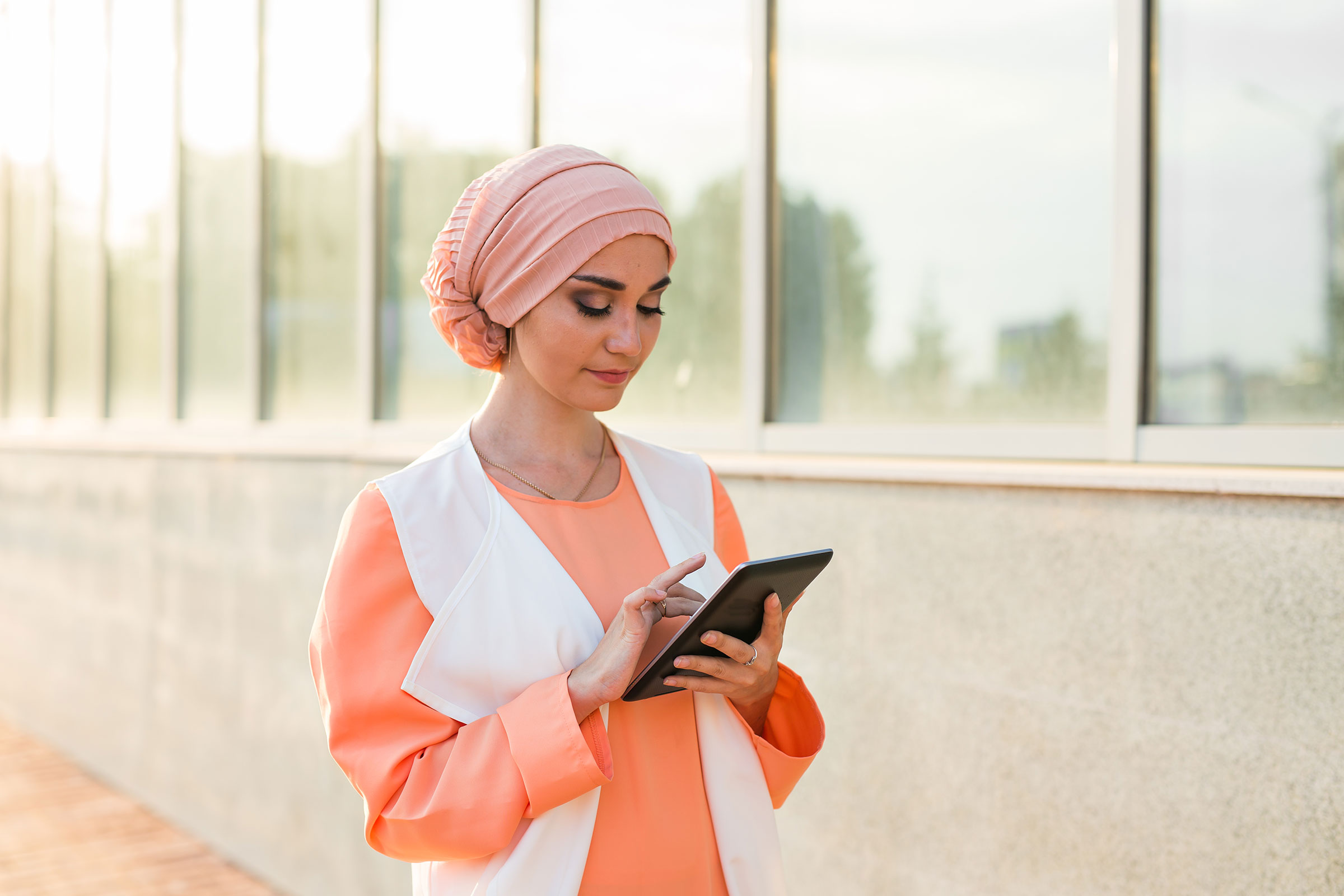 Arabian girl outside using tablet