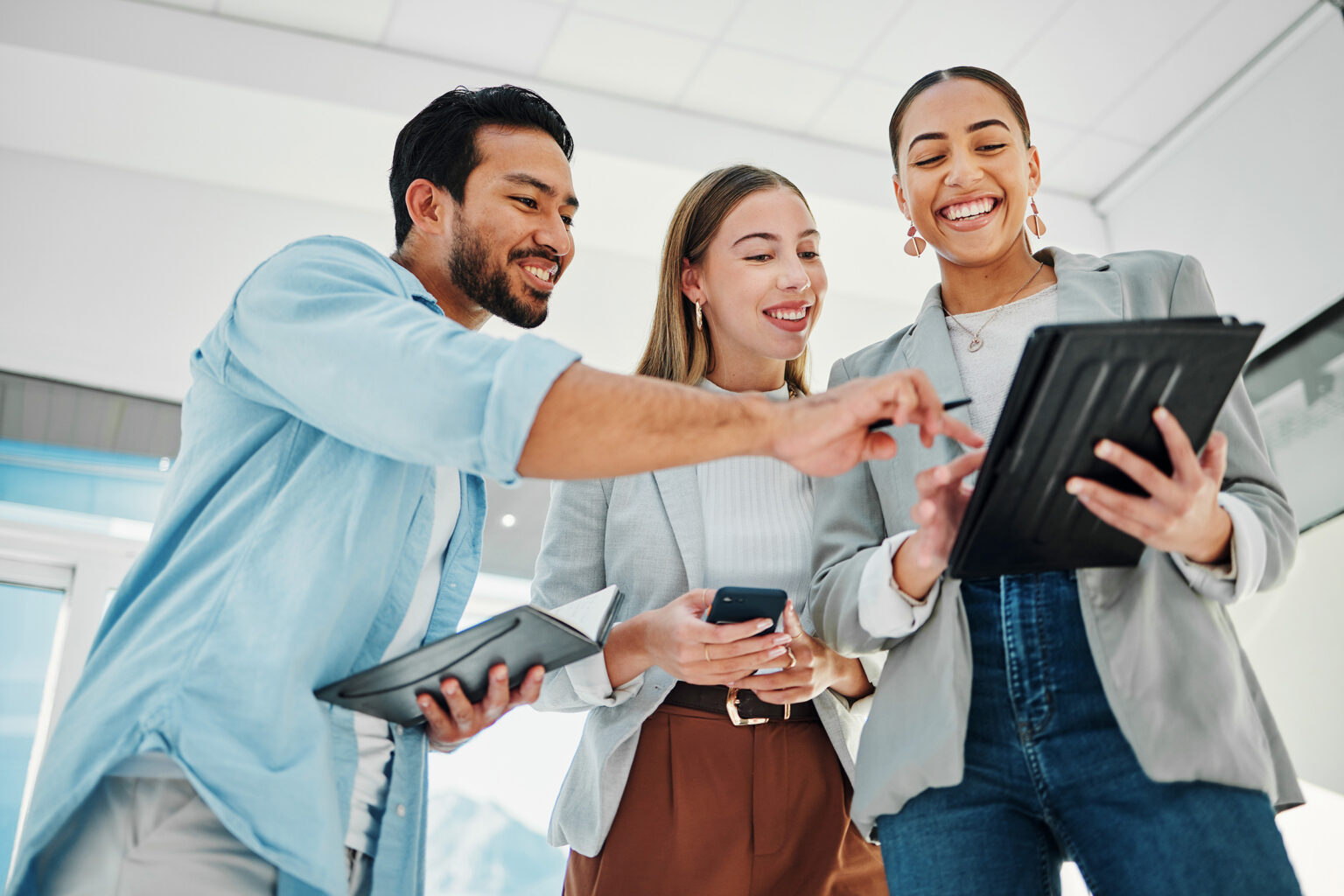 Diverse business people collaborate on a tablet