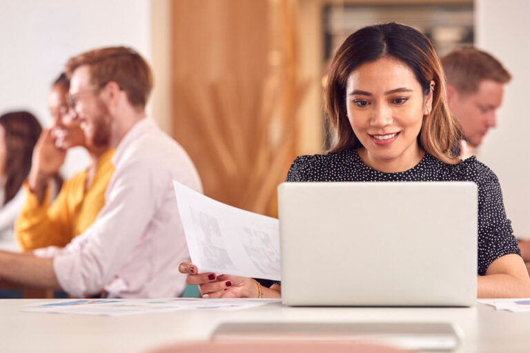 Business woman working at laptop in office