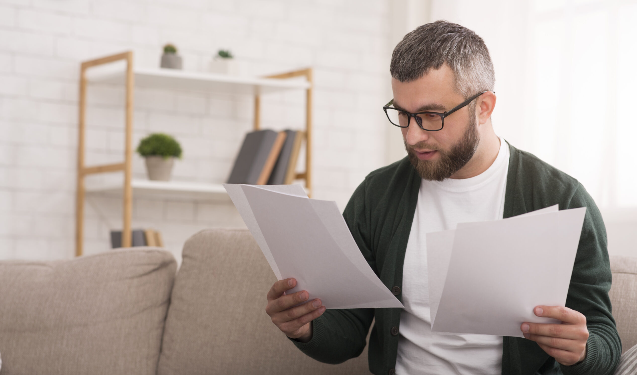 Businessman doing work at home, reading documents