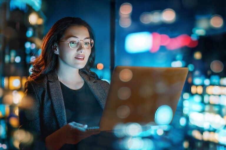 businesswoman working on laptop at night in city office