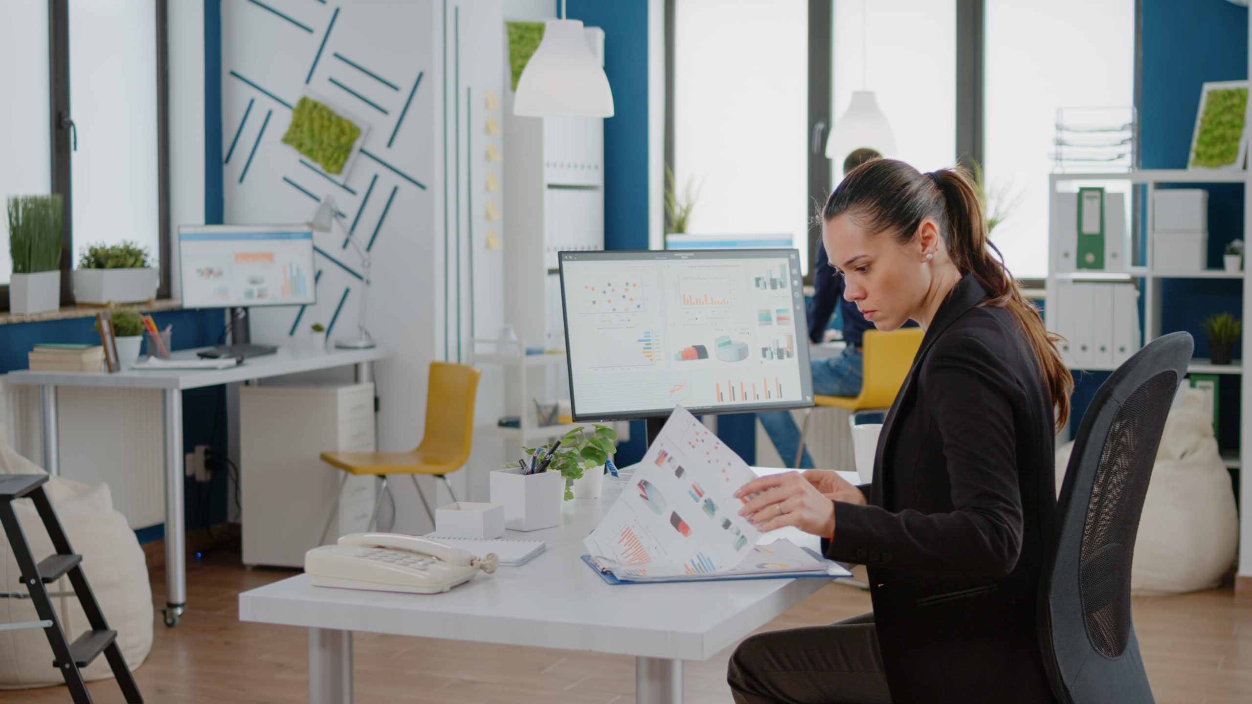 Focused professional analyzing data at her workstation.