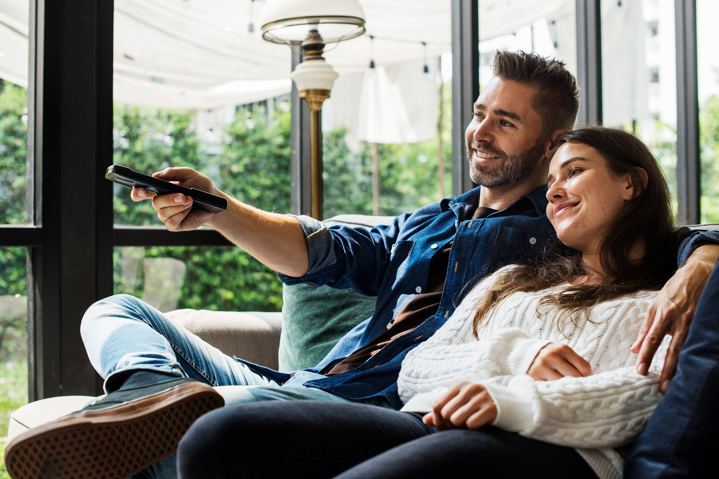 Happy couple watches tv together