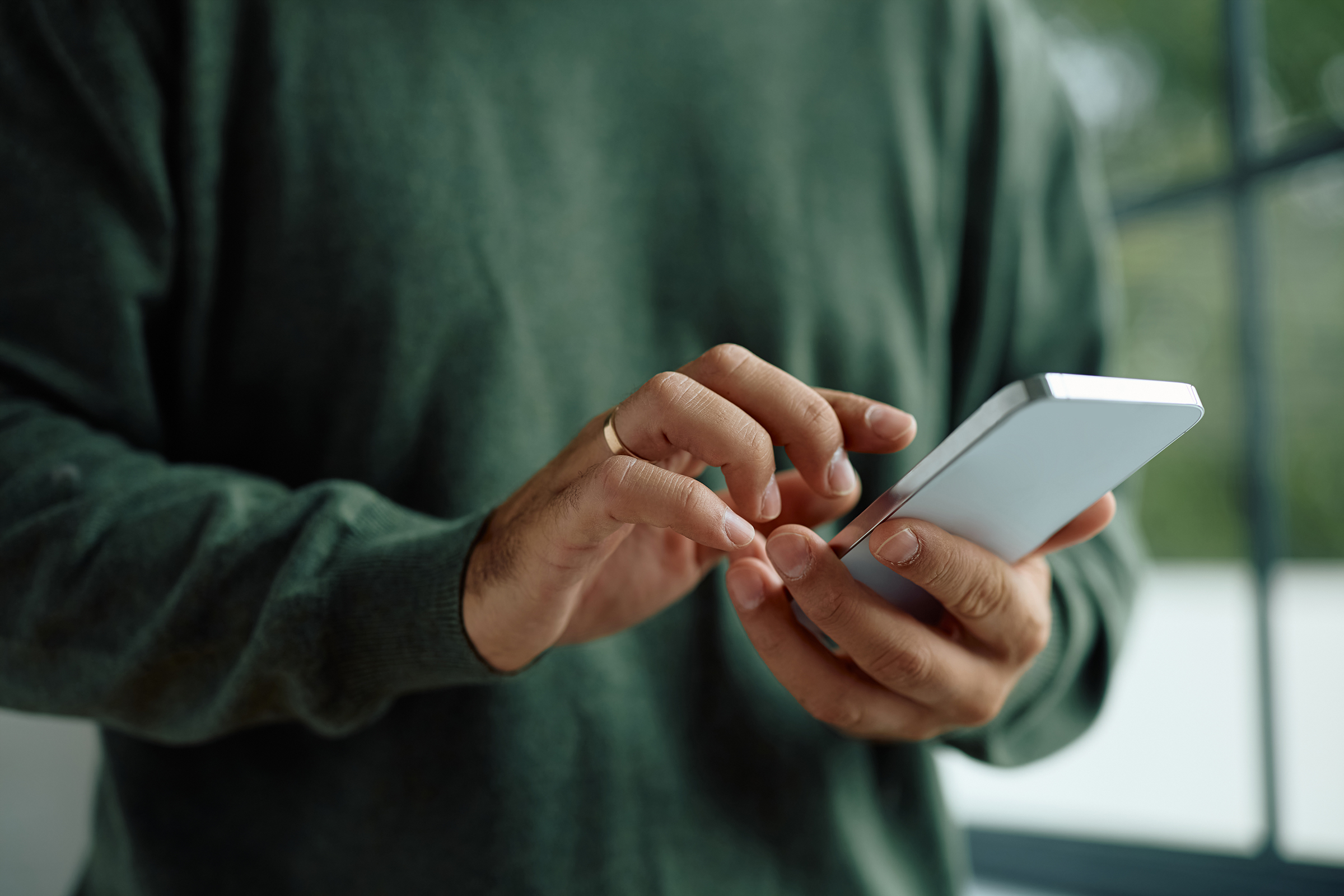 Close up of man using mobile phone.