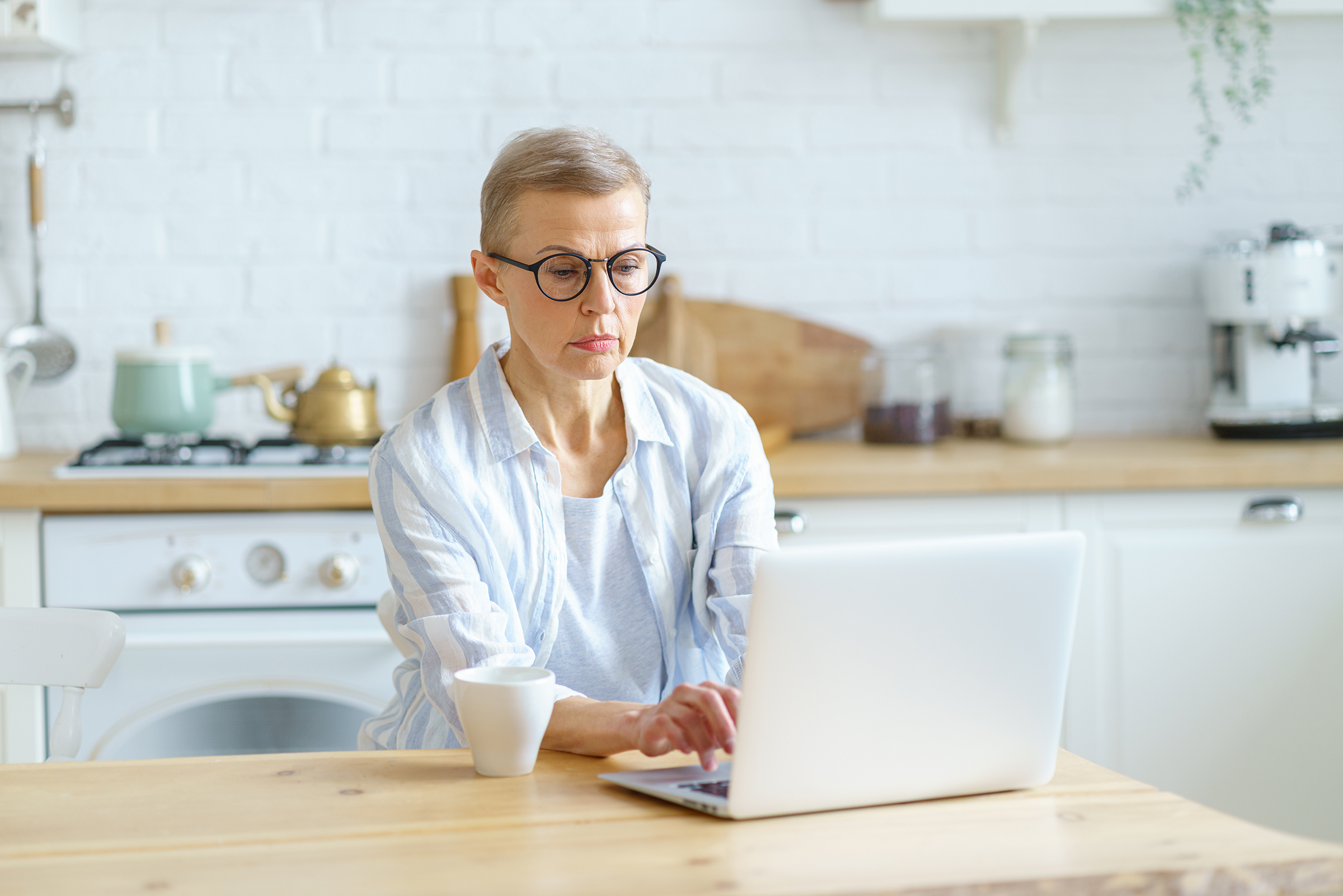 concentrated senior woman writer typing something