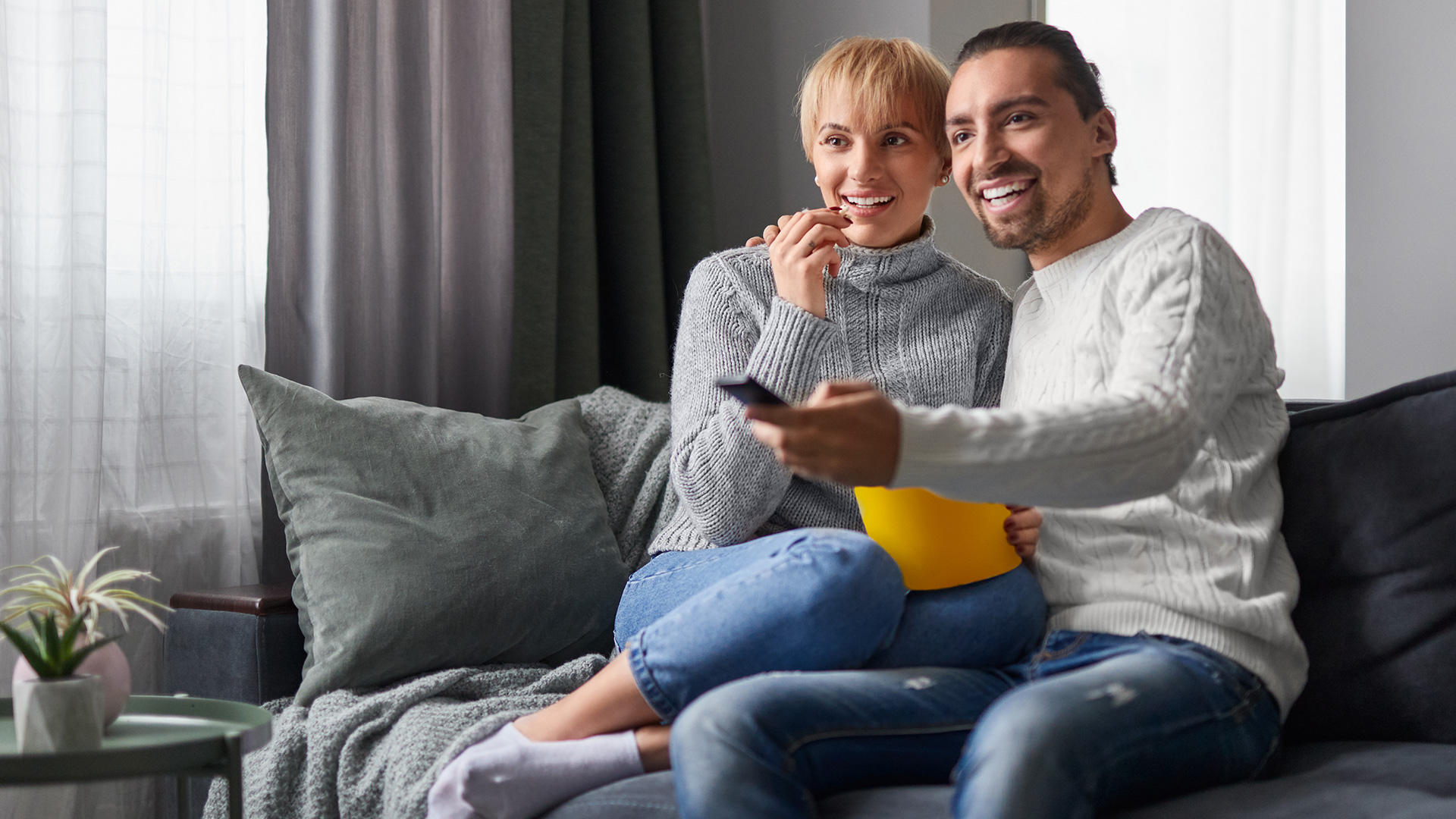 Couple watches television together at home