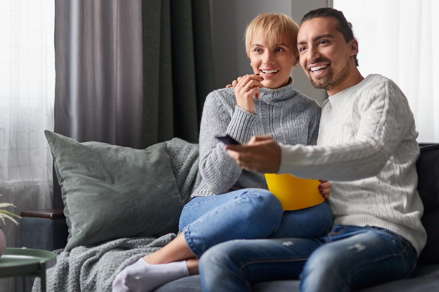 Couple watches television together at home