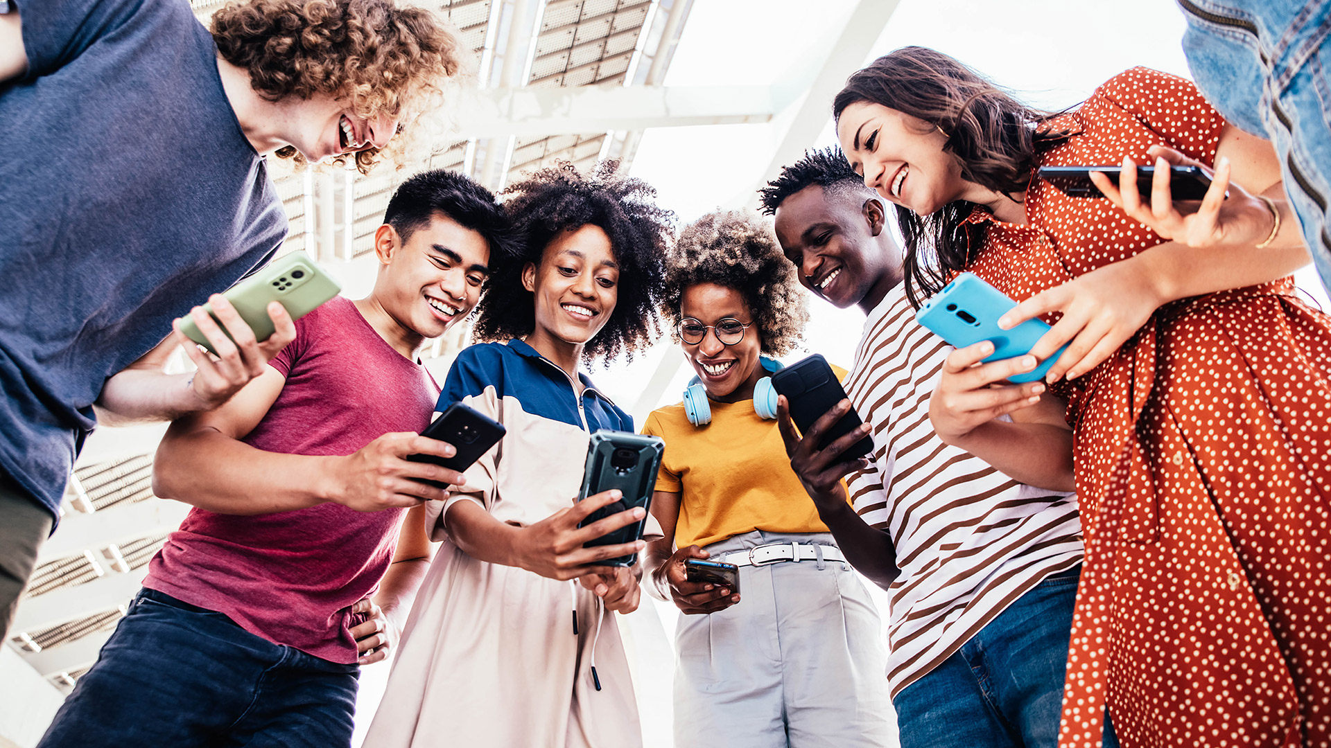 Group of diverse students using smart phones