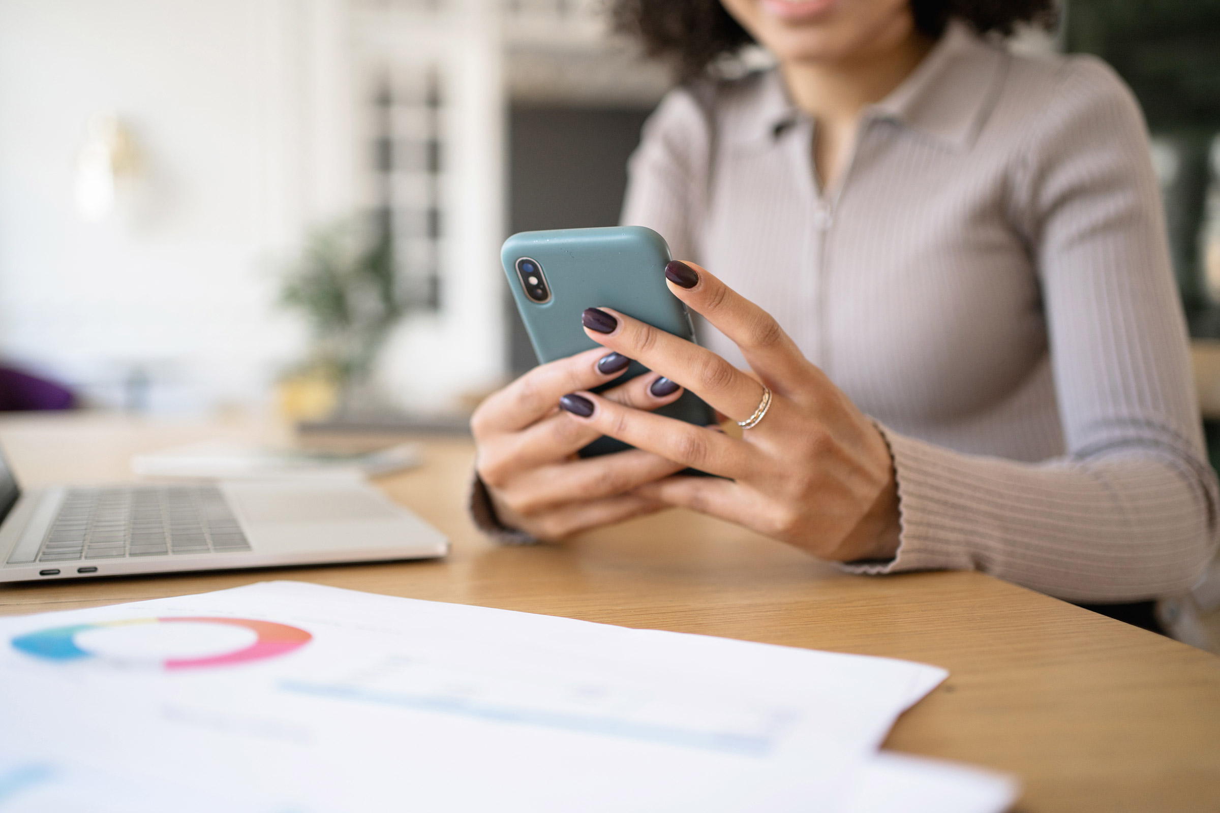 Manicured hands holding phone