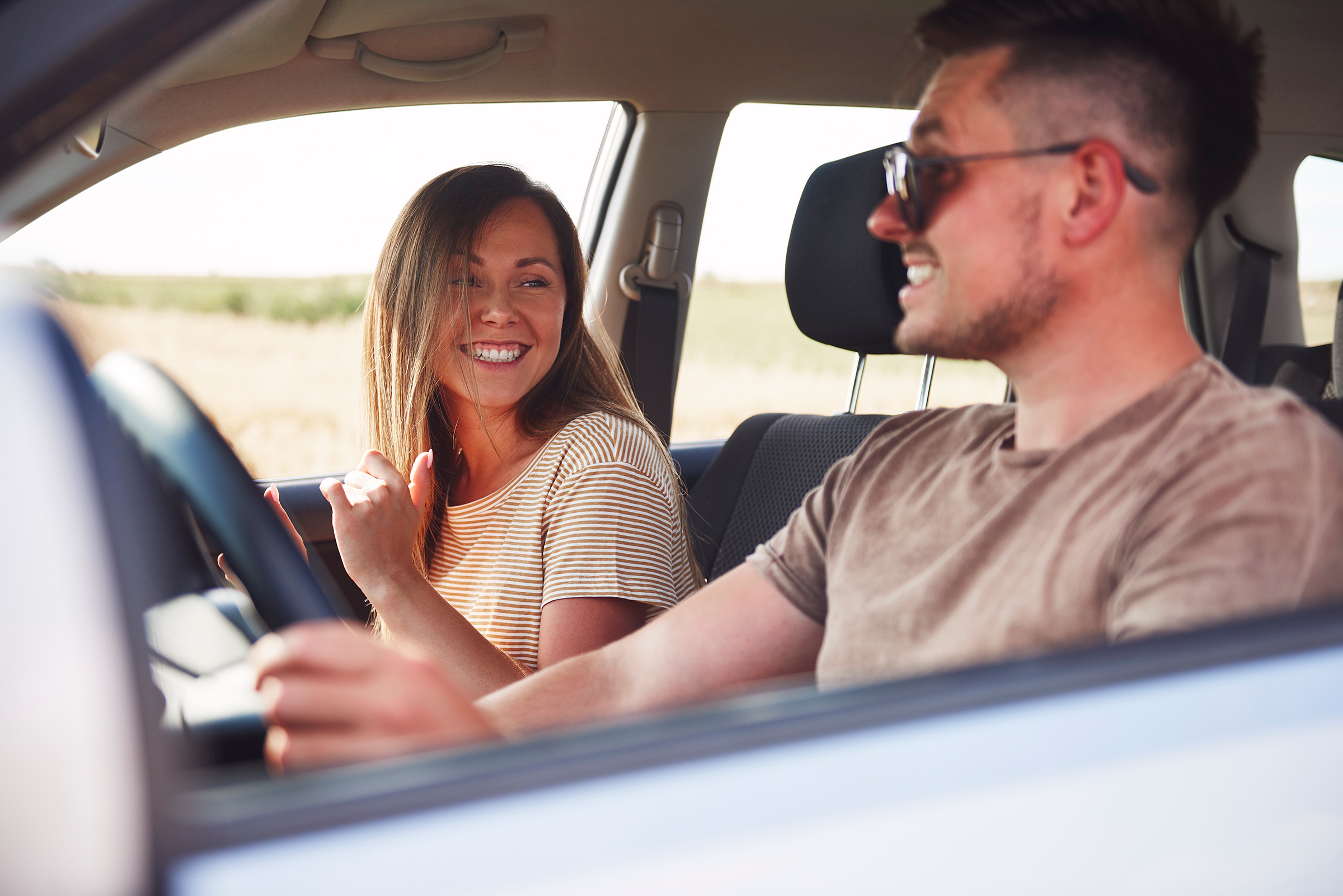 Happy couple having a fun during road trip in summertime