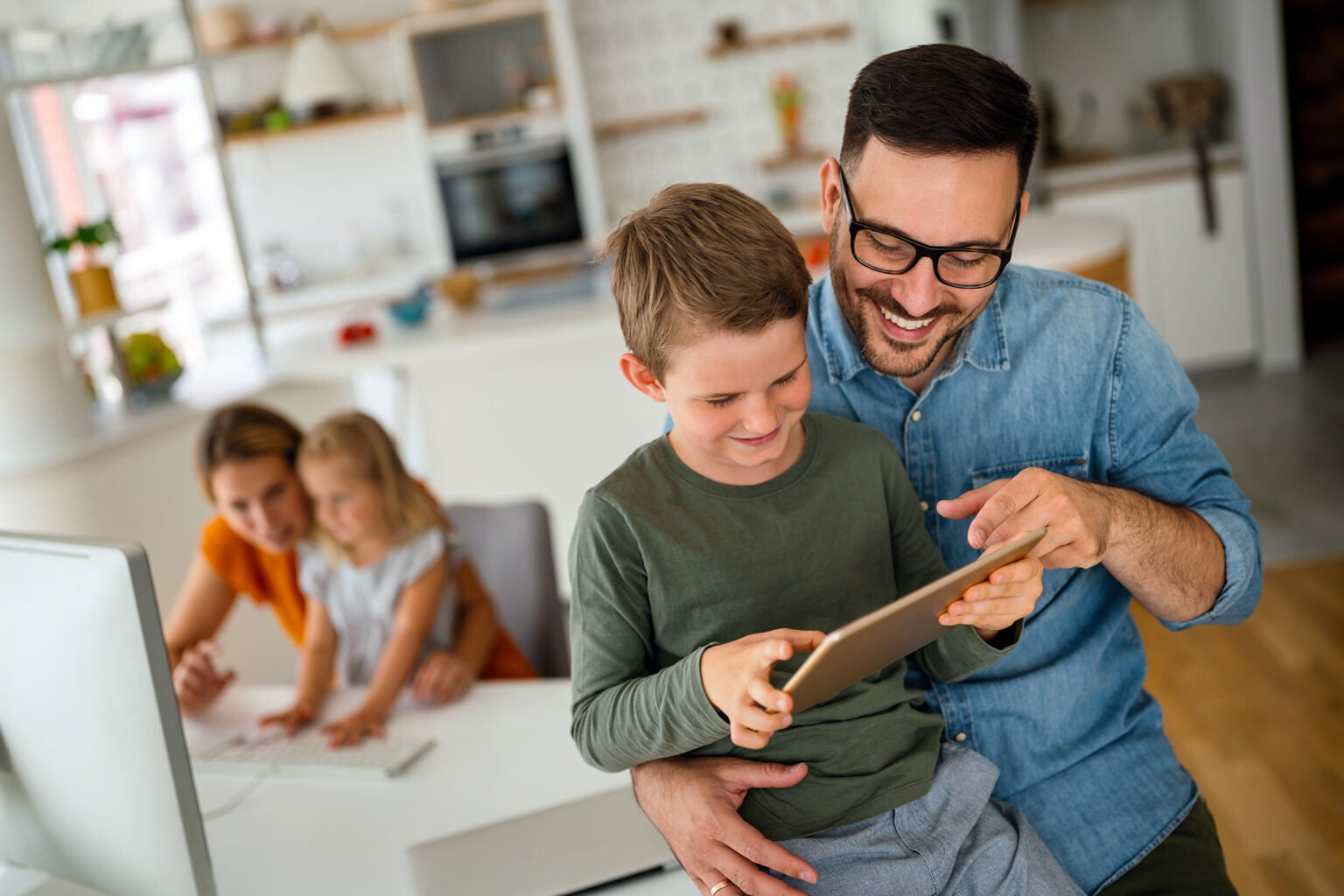 Happy father and son sharing a tablet