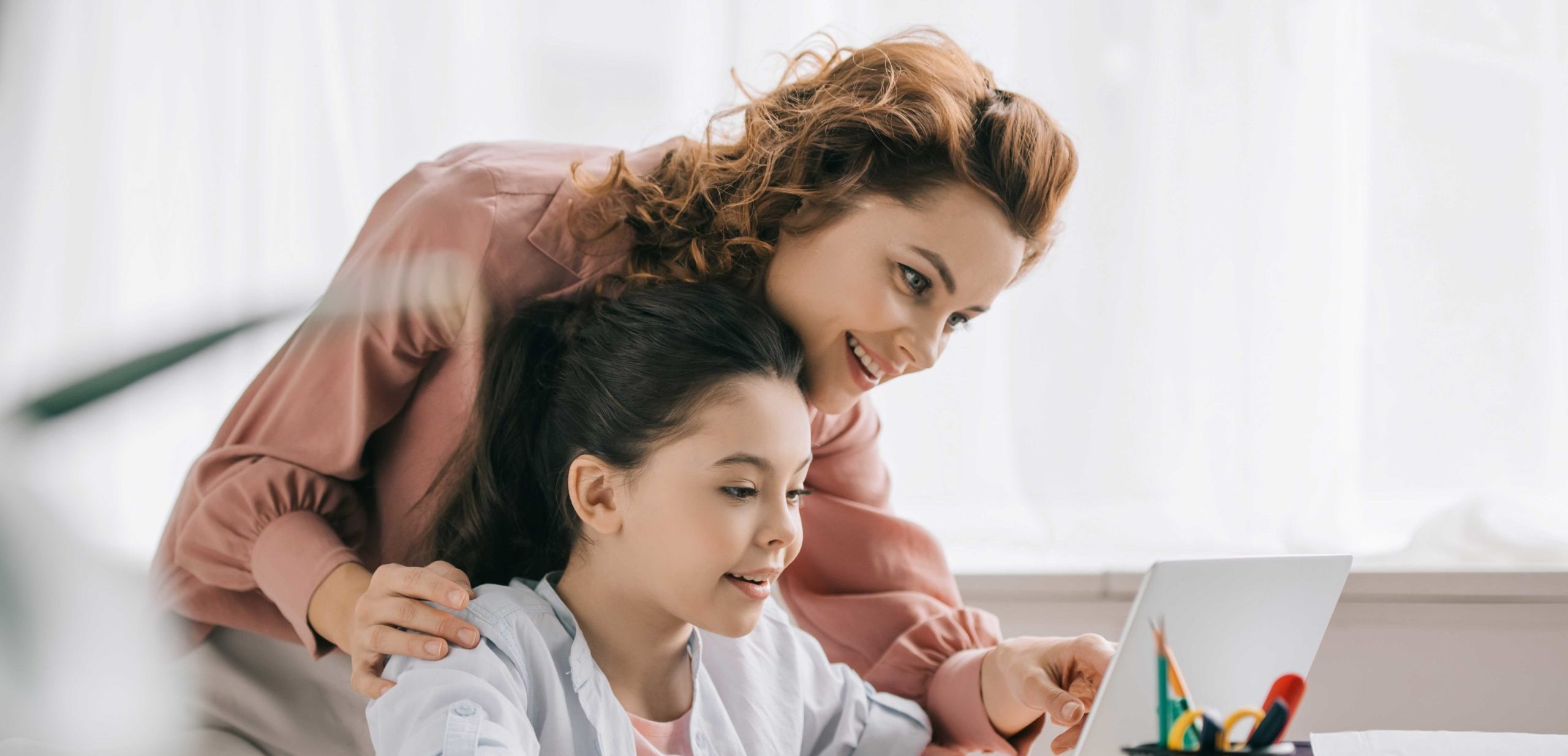 Mother and daughter looking at a laptop.