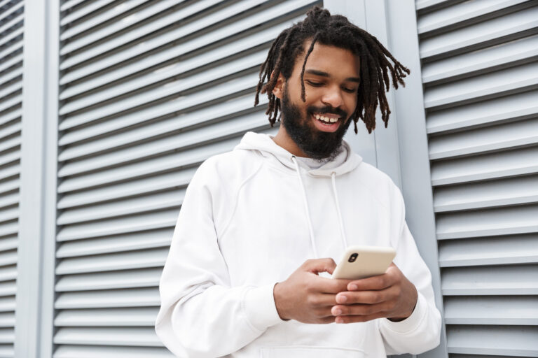 happy young man walking outdoors while chatting