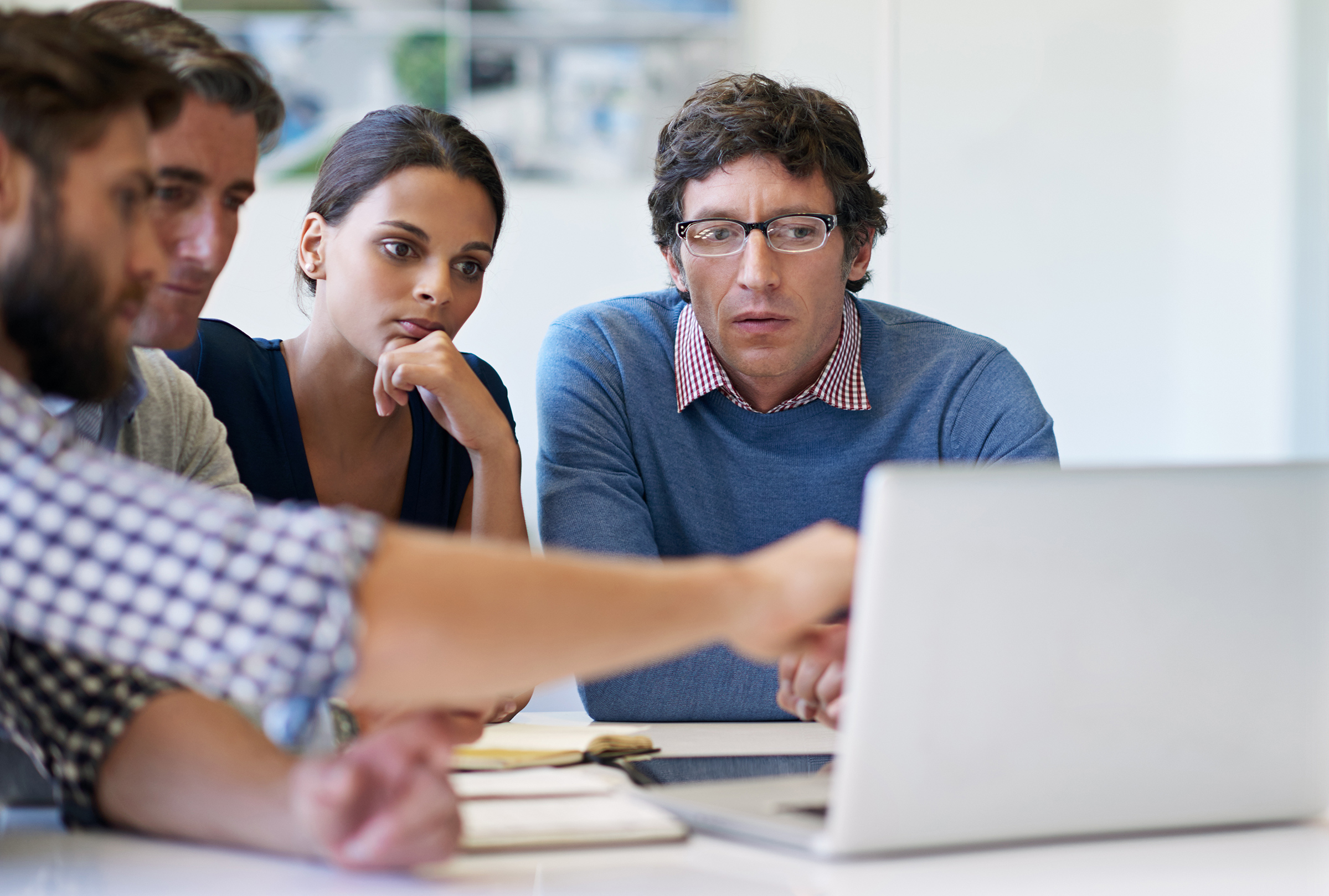 People working around laptop