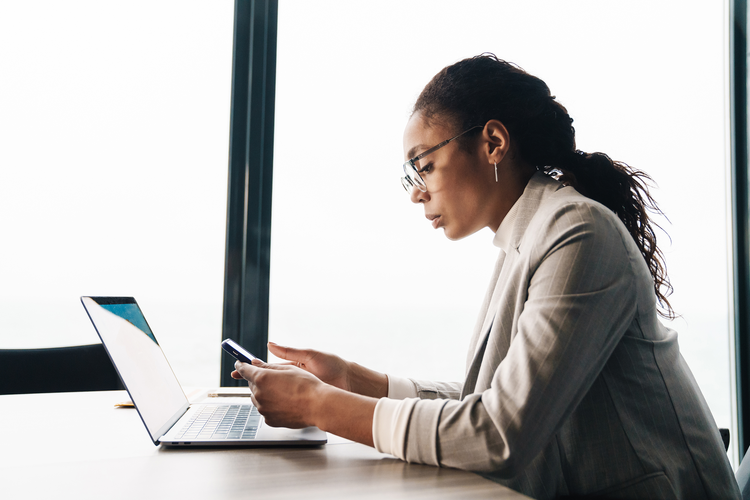 image of african american businesswoman using smartphone and laptop