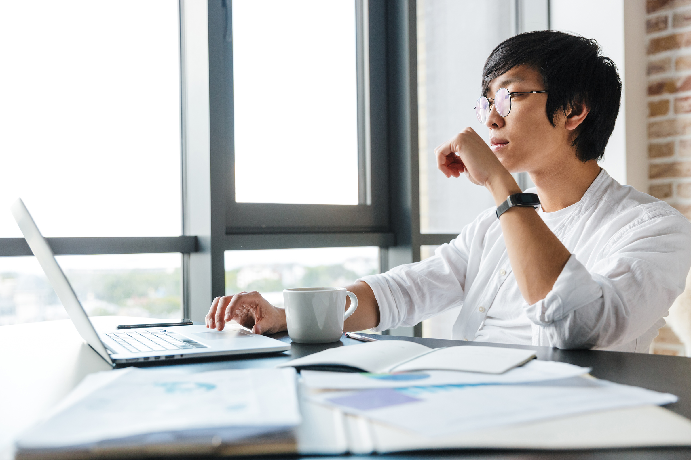 image of young asian man using laptop while sitting
