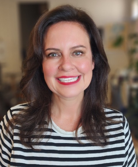 Professional portrait of a smiling woman with dark hair.