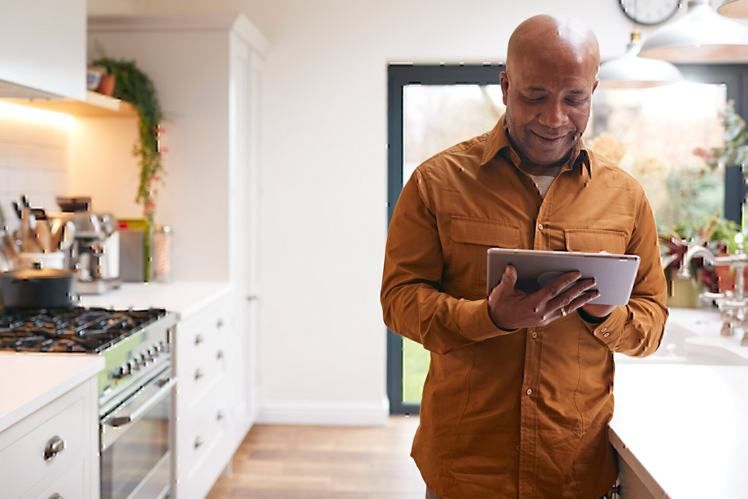 Man using digital tablet in kitchen