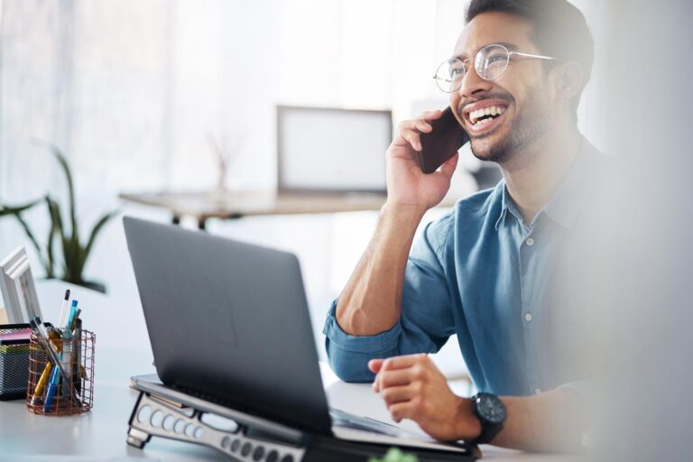 happy business man taking call at work