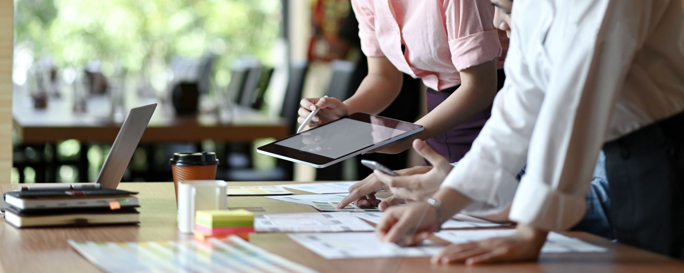 Businesswoman reviewing documents on a digital tablet.