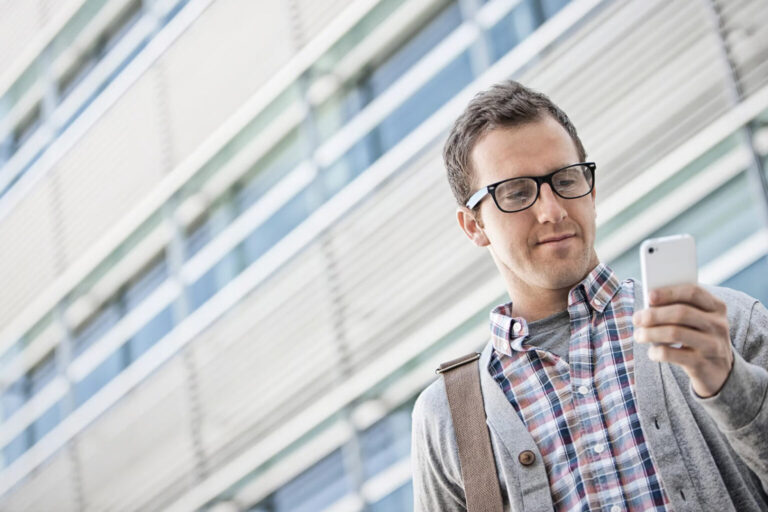 man looking at phone outside