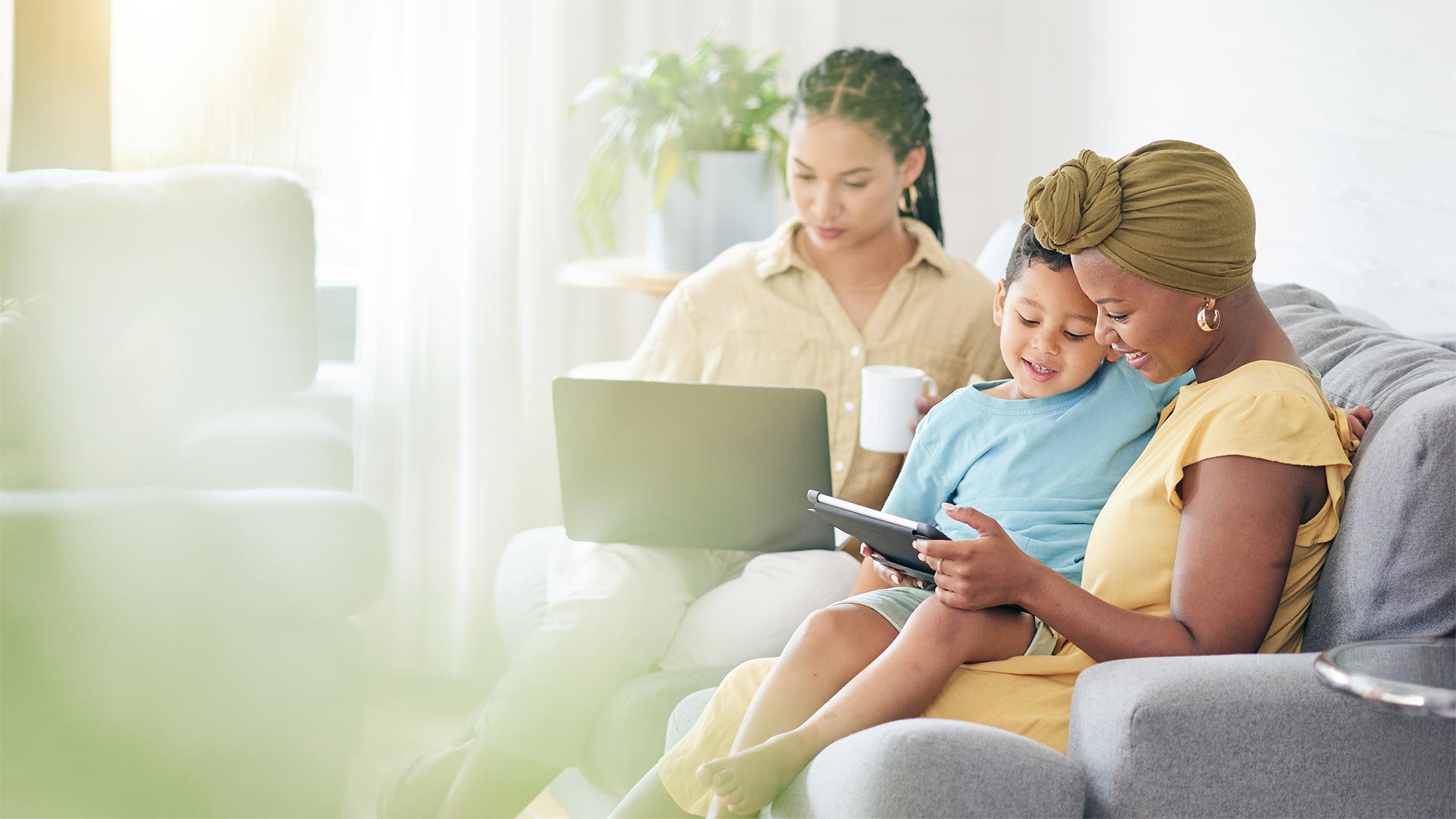 Family at home using devices on the couch