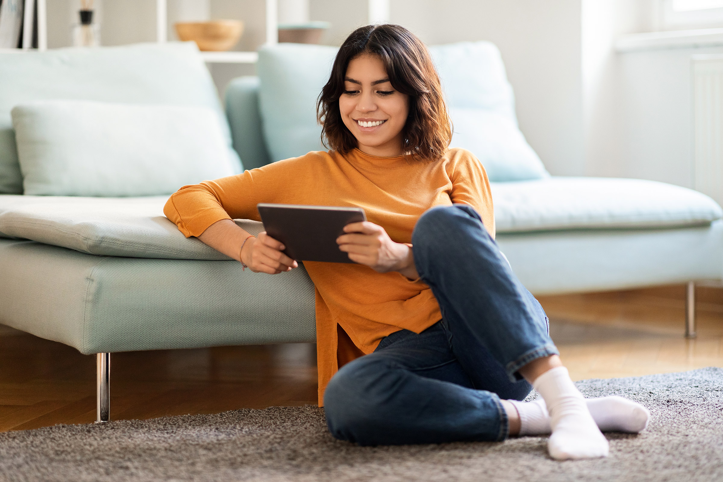 Young Arab woman relaxes at home with tablet