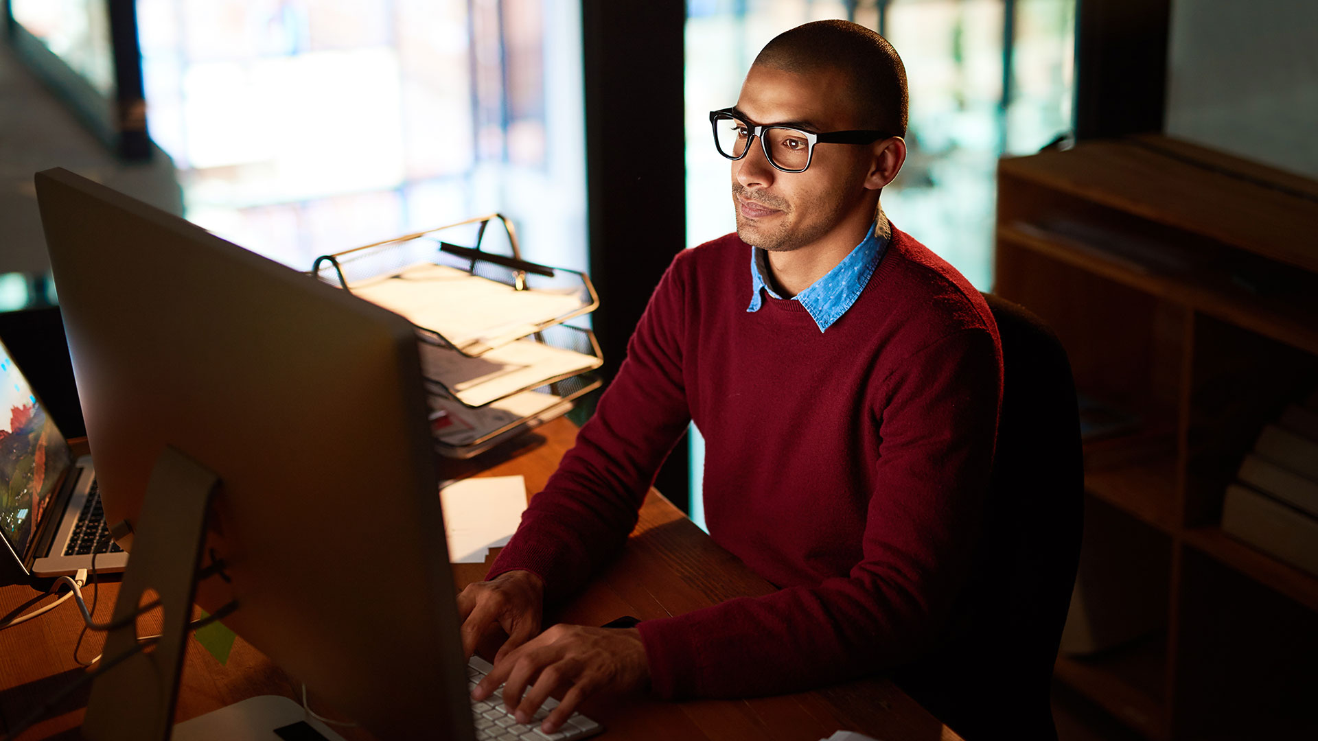 Business man on computer in low lighting