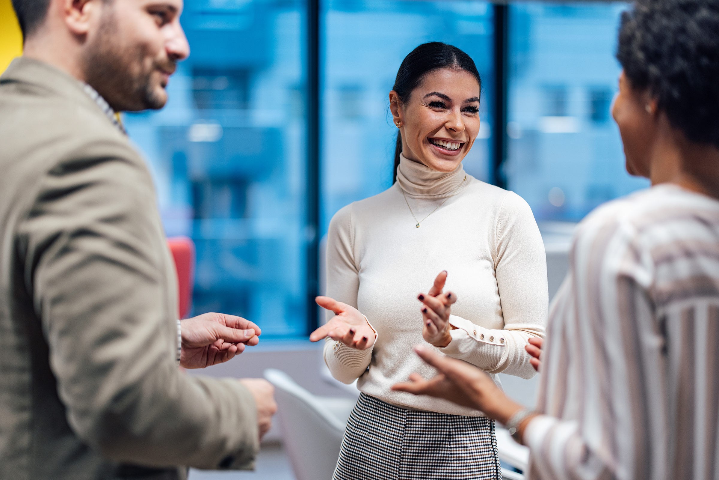 Two experienced colleagues, meeting a new employee in the office