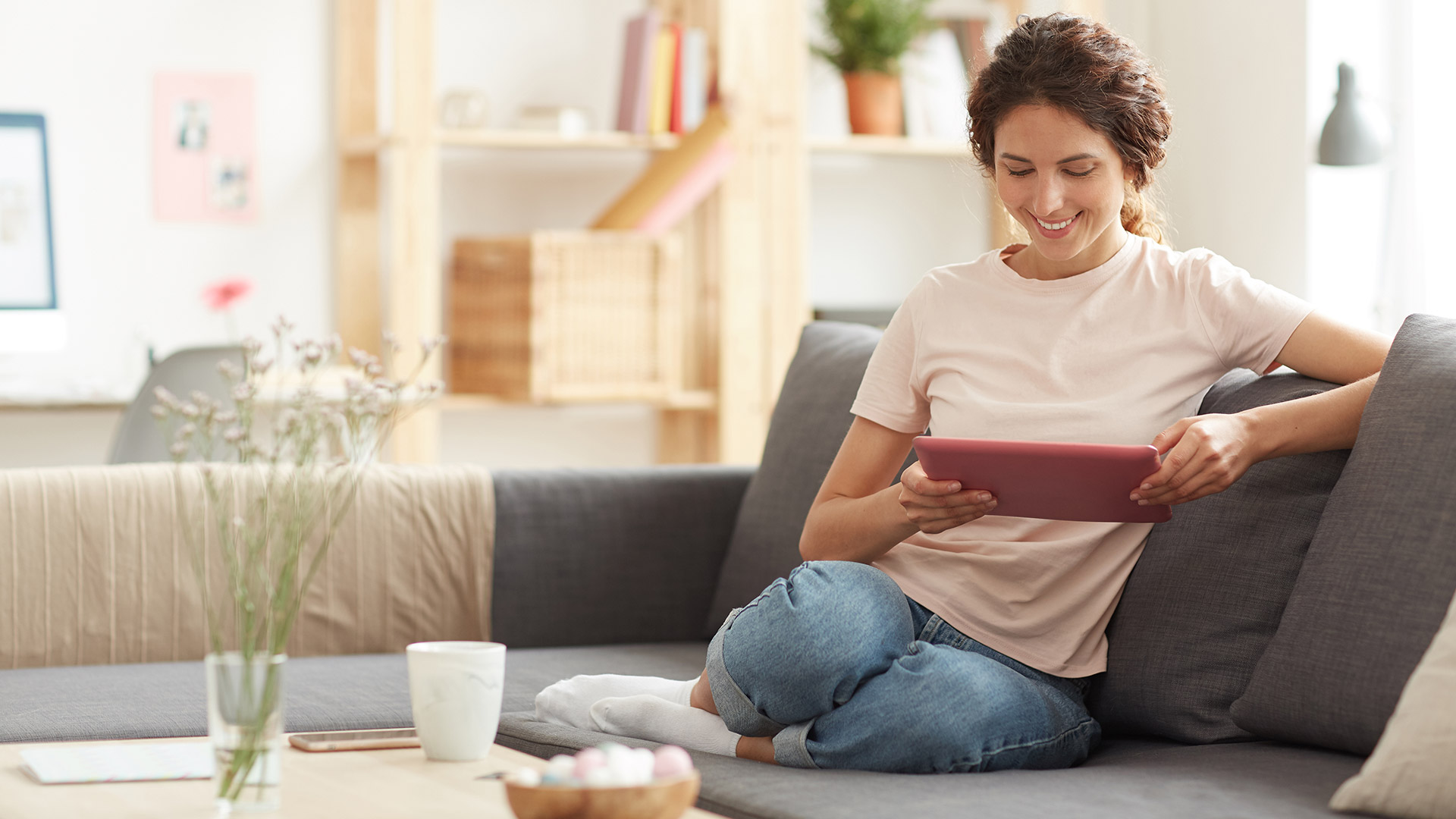 Woman using tablet at home on the couch