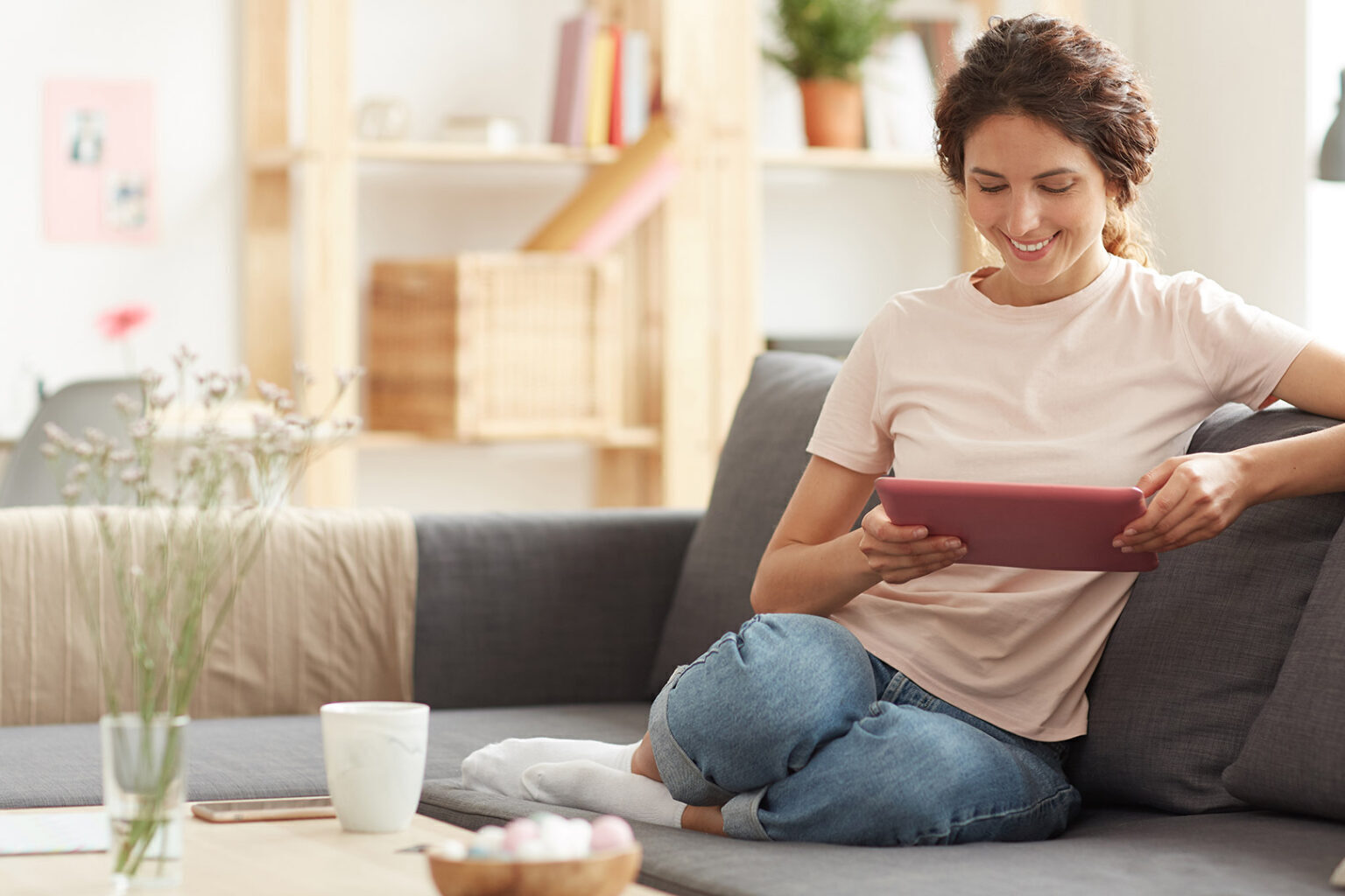 Woman using tablet at home on the couch