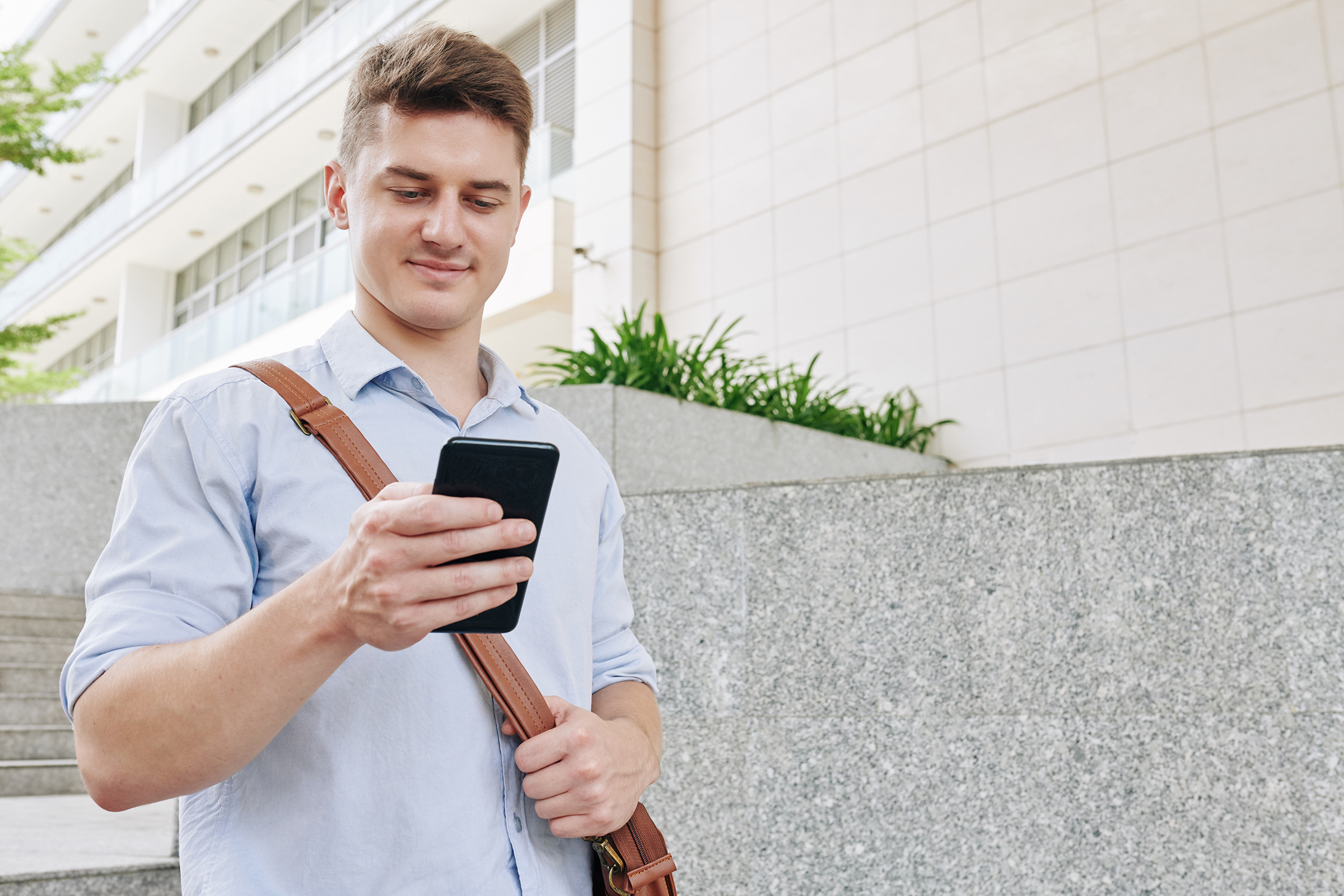 young entrepreneur checking text messages