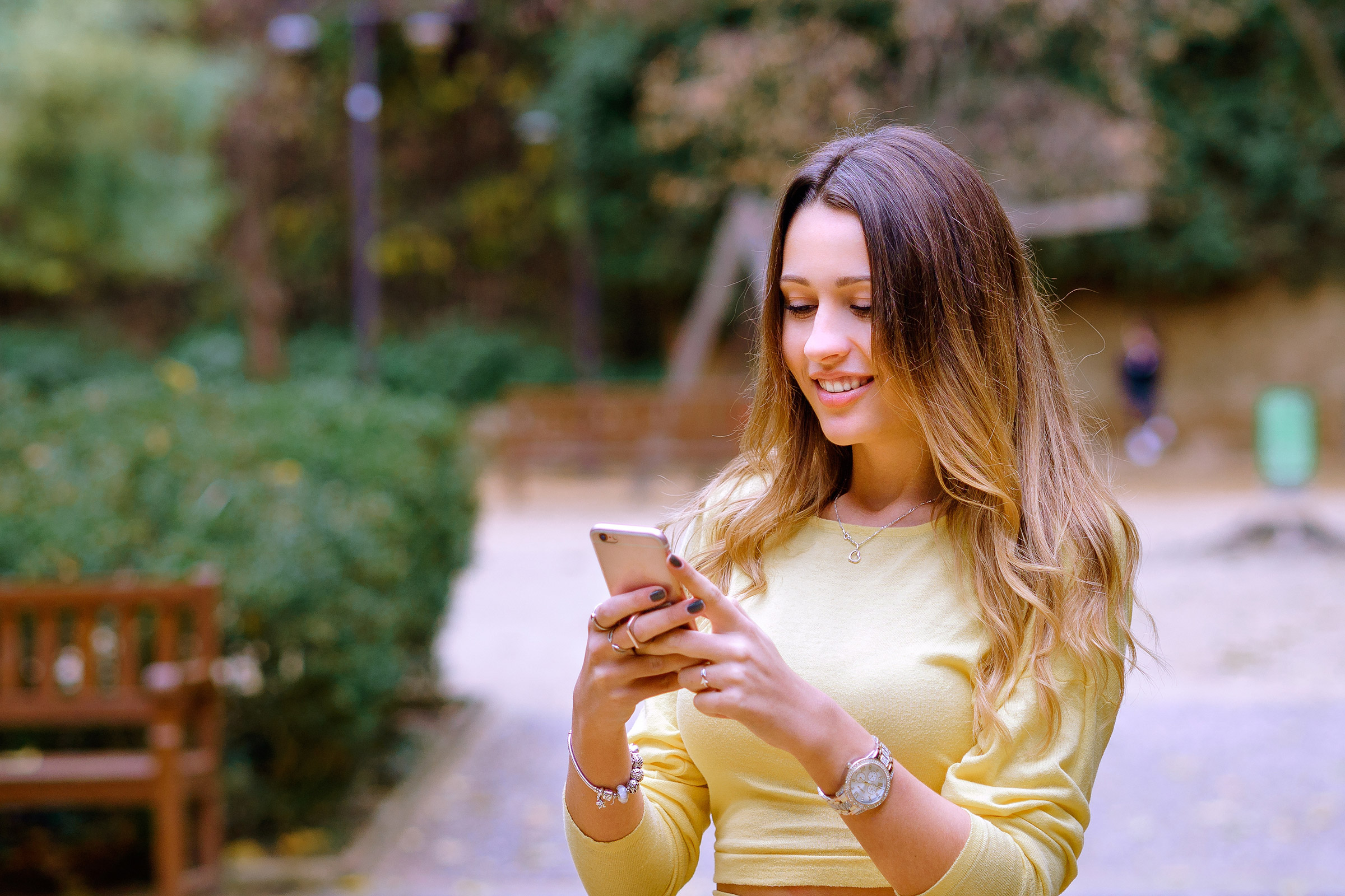 Young woman looking at her phone smiling