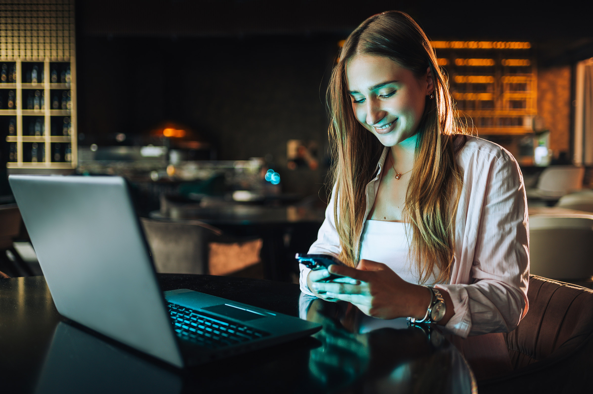 Young freelancer sitting in dark coffee shop